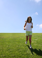 Image showing Girl running on grass
