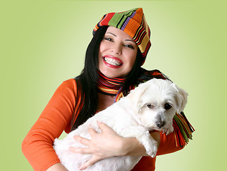 Image showing Woman holding a dog in her arms