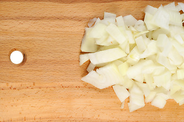 Image showing Chopped onions on a wooden board