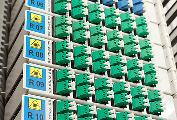 Image showing fiber optic rack with high density of blue and green SC connectors