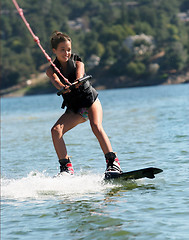 Image showing Girl wakeboarding on the lake