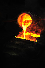 Image showing Foundry - molten metal poured from ladle into mould - emptying leftover