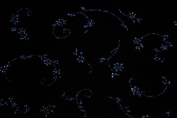 Image showing Elegant blue flowers on black fabric 