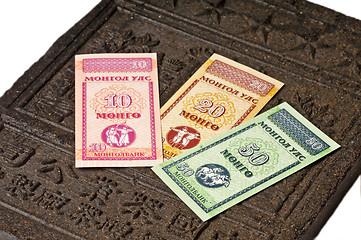 Image showing mongolian currency on tea brick