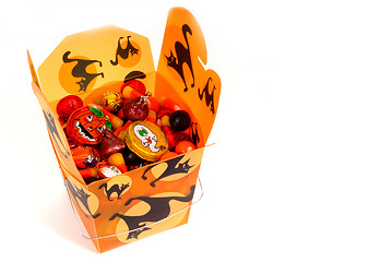Image showing Halloween candy in orange chinese container