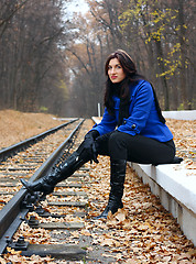 Image showing Young woman near the rails