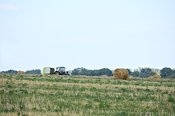 Image showing Tractor harvesting crop