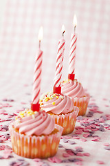 Image showing Pink muffins with candles