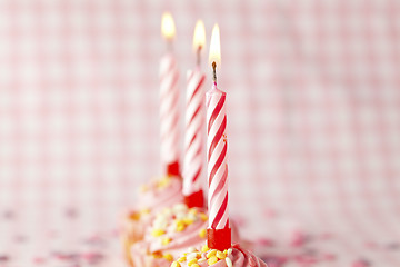 Image showing Pink muffins with candles