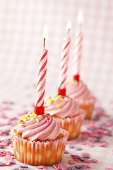 Image showing Pink muffins with candles