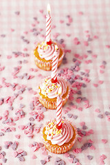 Image showing Pink muffins with candles