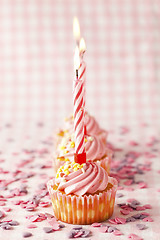 Image showing Pink muffins with candles