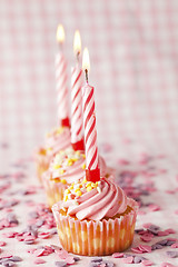 Image showing Pink muffins with candles