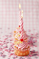 Image showing Pink muffins with candles