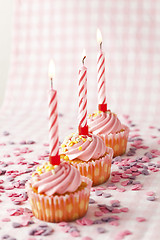 Image showing Pink muffins with candles