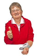 Image showing pensioner is measuring her blood pressure