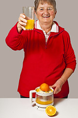 Image showing pensioner drinks orange juice