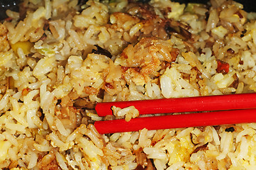 Image showing baked rice with chopsticks