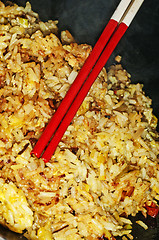 Image showing baked rice with chopsticks