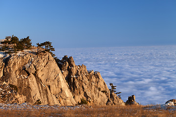 Image showing Mountains at sunset and sea in clouds