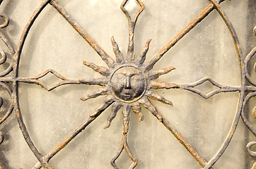 Image showing Closeup of decorative metal gate. Sun in middle. 