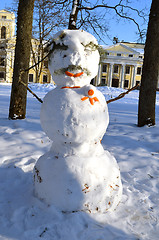 Image showing Snow man decorated with orange bark spruce branch 