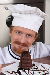 Image showing Young chef with piece of cake