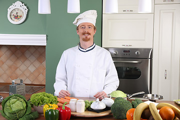 Image showing Young chef preparing lunch in kitchen