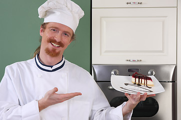 Image showing Young chef with piece of cake