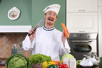 Image showing Funny young chef preparing lunch in kitchen