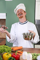 Image showing Young chef preparing lunch in kitchen