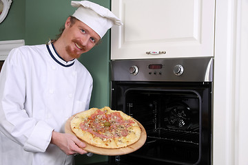 Image showing young chef with italian pizza in kitchen