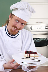 Image showing Young chef with piece of cake