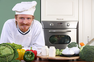 Image showing Young chef preparing lunch in kitchen