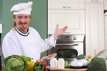 Image showing Young chef preparing lunch in kitchen