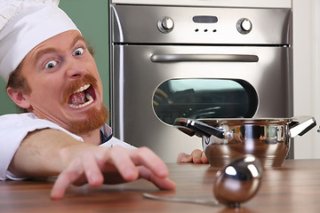 Image showing Funny young chef with a pot