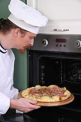 Image showing Young chef prepared italian pizza in kitchen