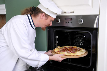 Image showing Young chef prepared italian pizza in kitchen 