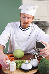 Image showing Young chef preparing lunch in kitchen