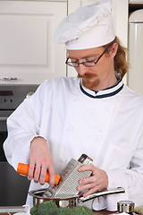 Image showing Young chef preparing lunch in kitchen