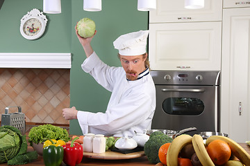 Image showing Young chef preparing lunch in kitchen