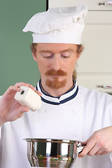 Image showing Young chef preparing lunch in kitchen