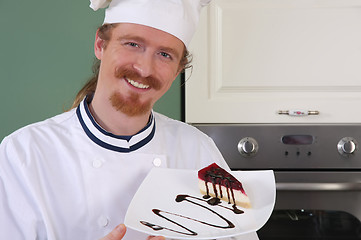 Image showing Young chef with piece of cake