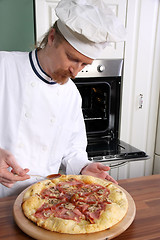 Image showing Young chef prepared italian pizza in kitchen