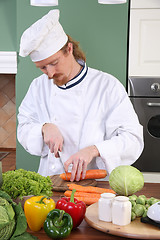 Image showing Young chef preparing lunch in kitchen