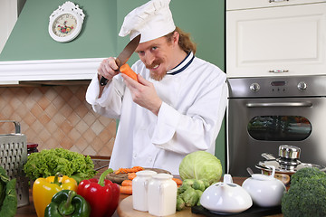 Image showing Young chef preparing lunch in kitchen