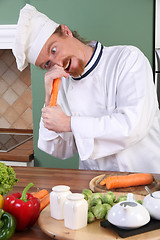 Image showing Young chef preparing lunch in kitchen