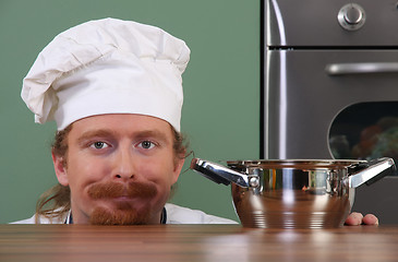 Image showing Funny young chef with a pot