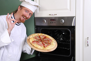 Image showing young chef with italian pizza in kitchen 