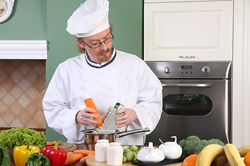 Image showing Young chef preparing lunch in kitchen